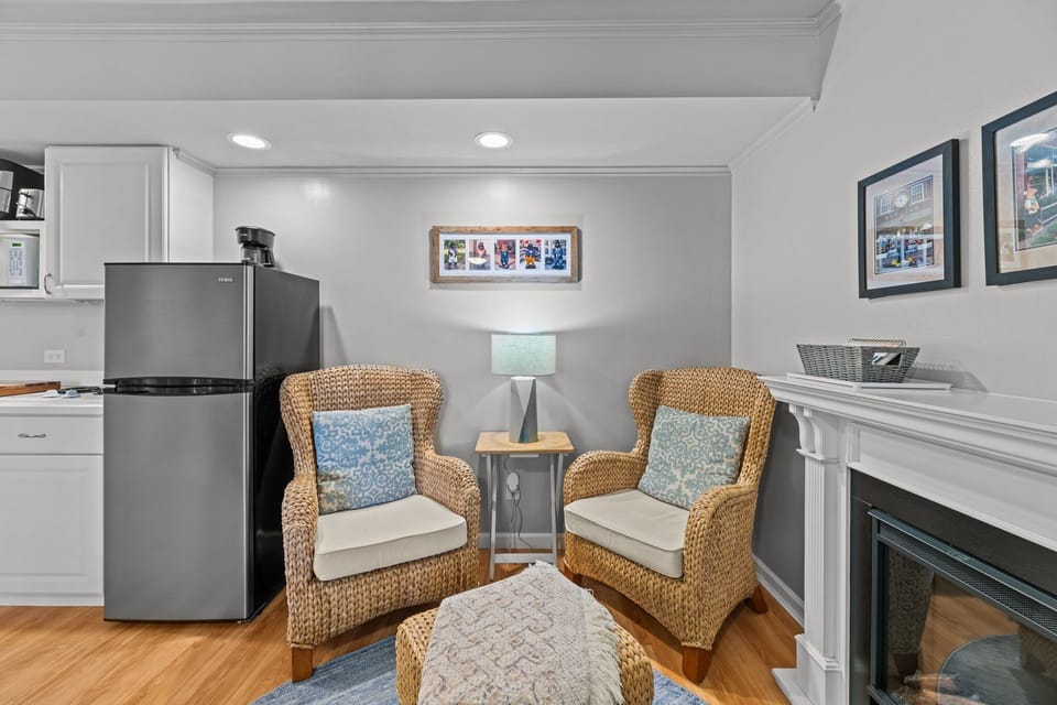 "Cozy up by the warm, inviting faux fireplace.