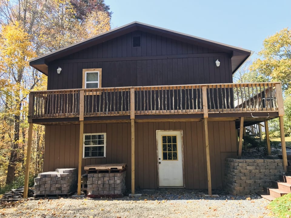 Side of cabin. Private parking. Walkway to the right. Fire pit to the left. 
