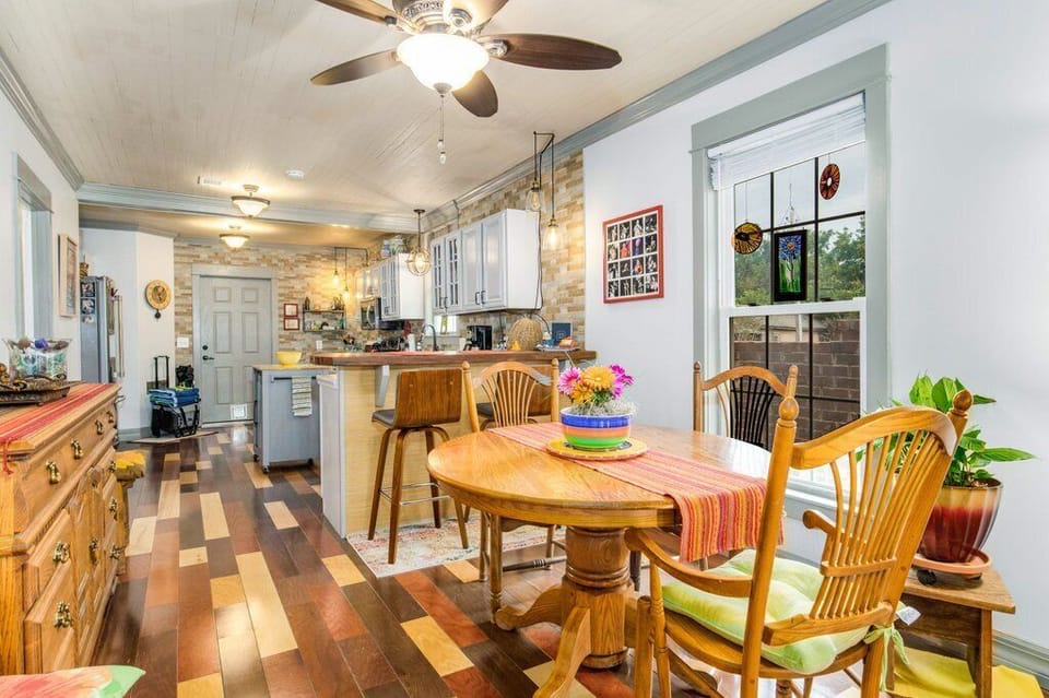 Bright dining space at the Boho Bungalow invites couples or small adult families to share slow mornings over coffee in this historic downtown Pensacola neighborhood.
