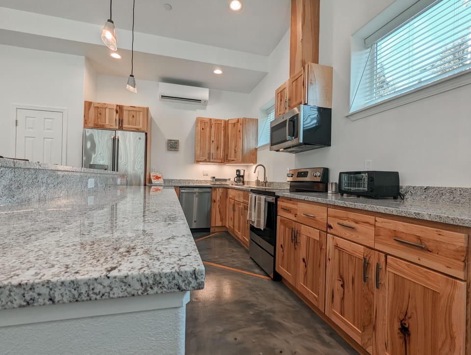 Modern kitchen with stainless appliances and ample prep space