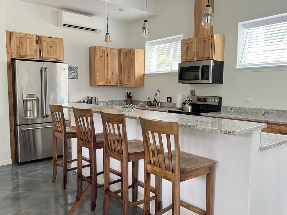 Fully equipped kitchen with granite countertops and seating for group meals