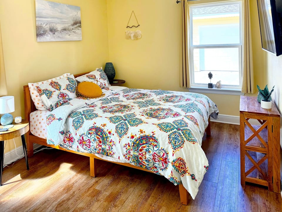Sunny, cheerful bedroom with colorful bedding and cozy coastal charm