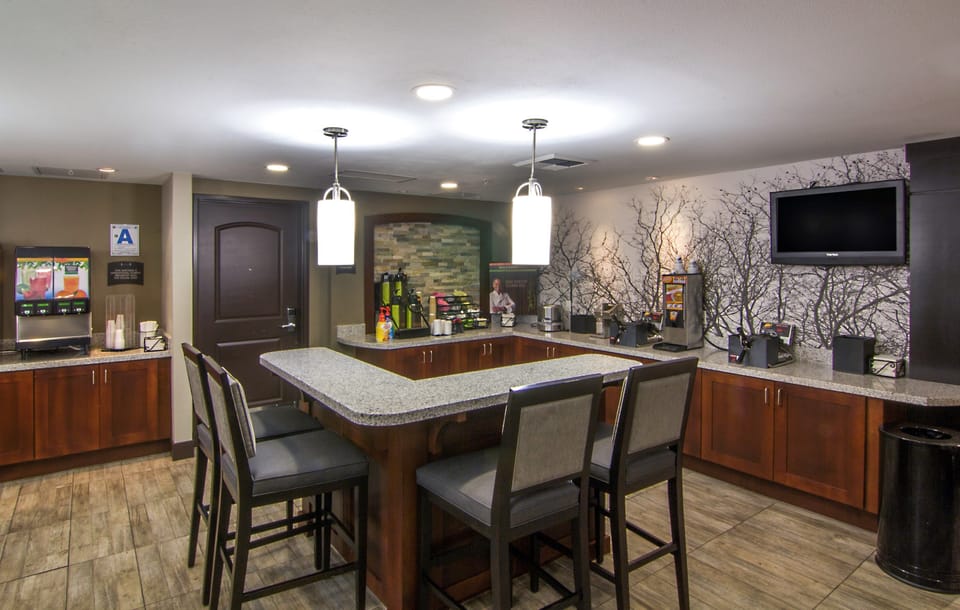 Common area with bar-style seating and coffee station.