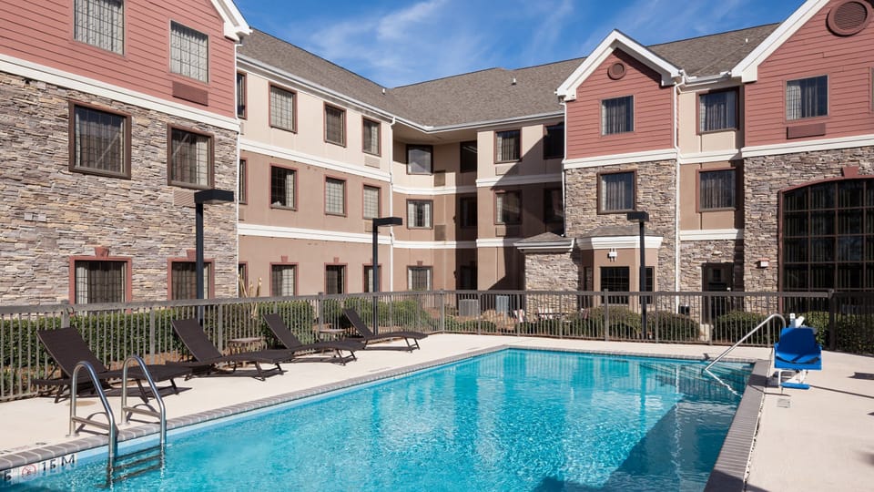 Take a refreshing dip in the clear blue pool, surrounded by cozy lounge chairs.