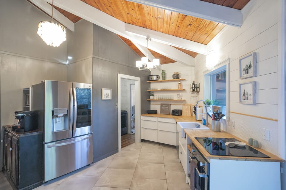 Nice appliances and fully stocked kitchen.