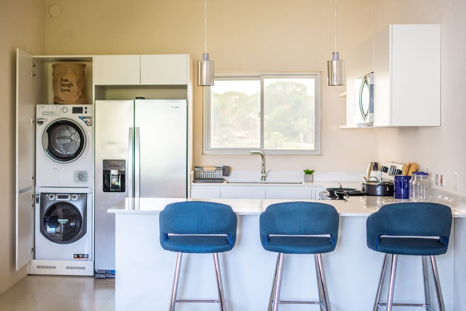 stackable washer & dryer near the fridge for extra convenience during the stay