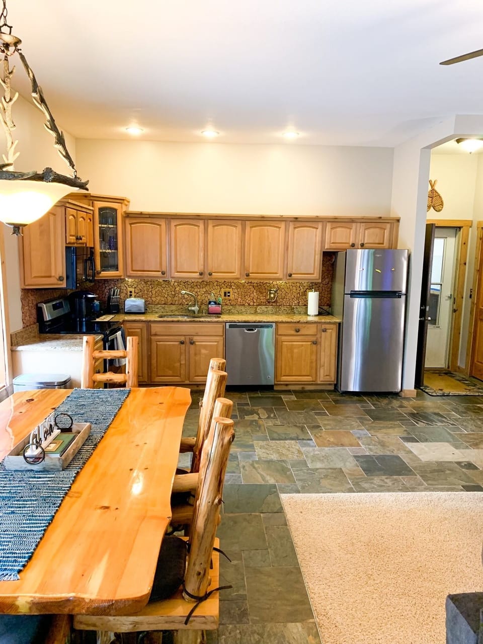 Open concept kitchen/living with soaring 10ft ceilings throughout the cabin 