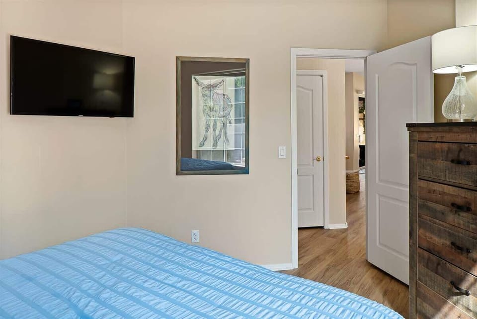 The second bedroom has a queen bed and flat screen TV