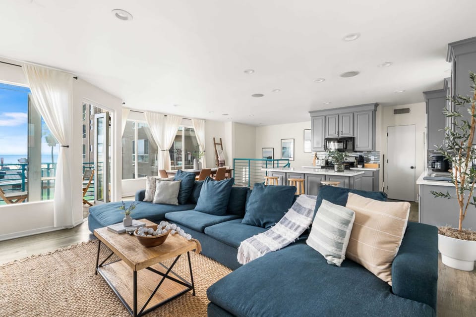 Relax in the spacious living room with breathtaking ocean views, perfect for unwinding after a day at the beach.