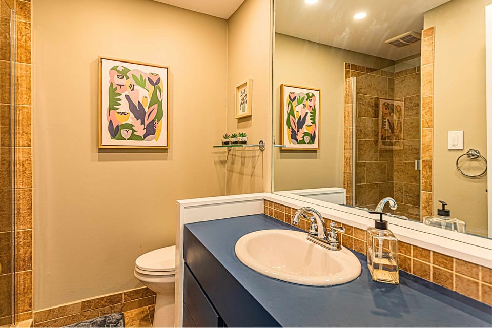 Walk-in shower, ample counter space, stylish design.