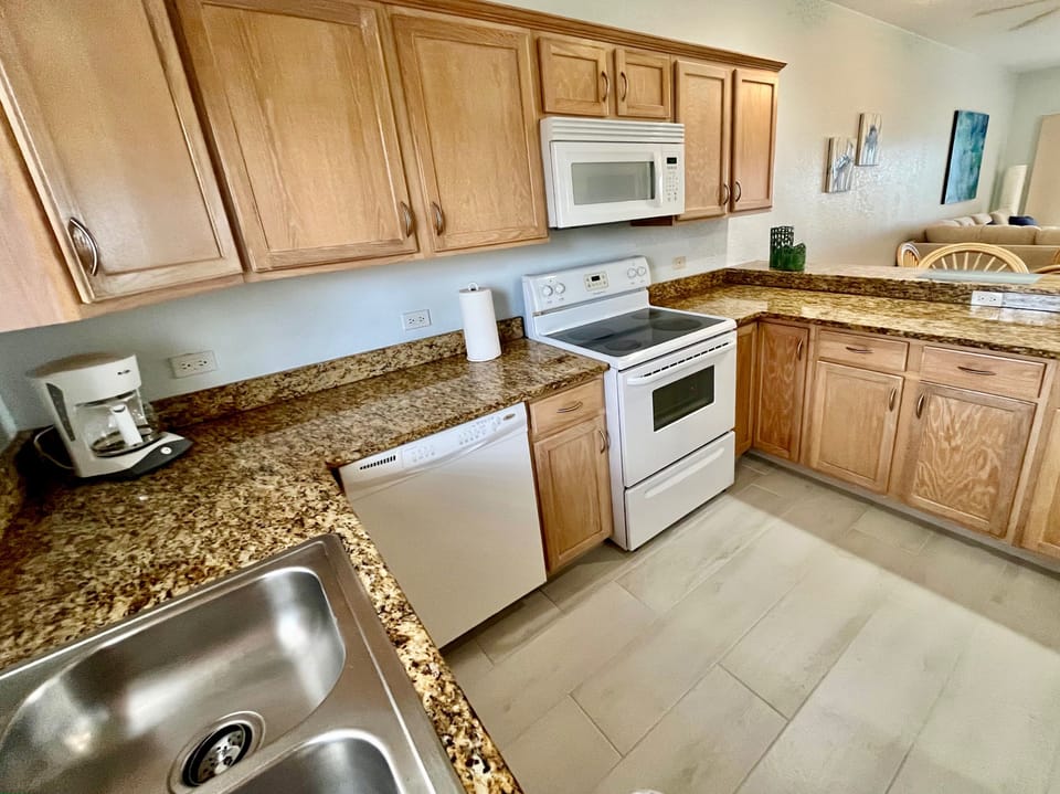 Kitchen has fridge freezer, oven, cook top, microwave and dishwasher.
