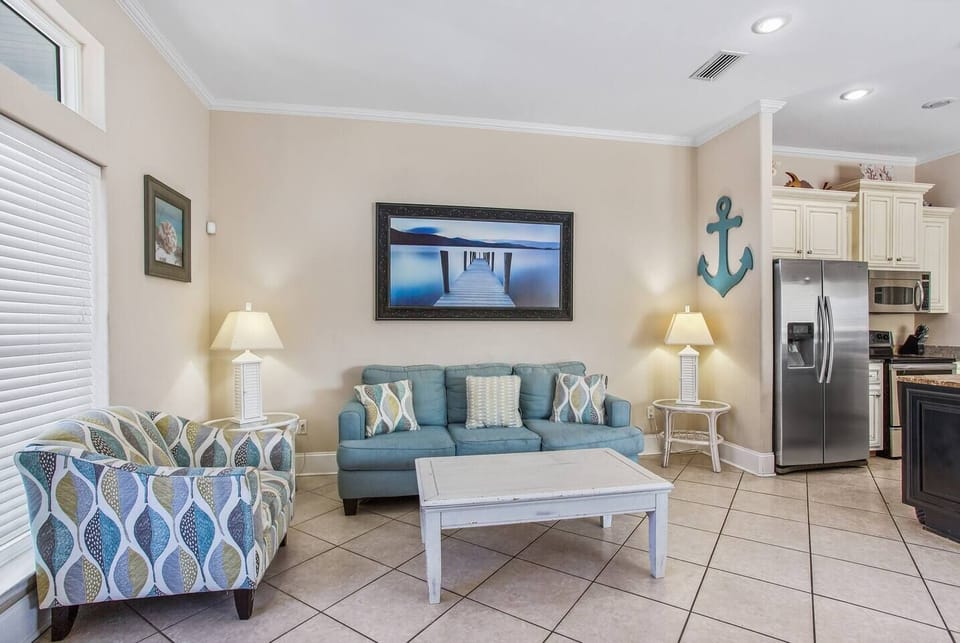 Living room with brand new sofa with queen sleeper sofa and large smart TV, providing comfortable seating and flexible sleeping for groups.