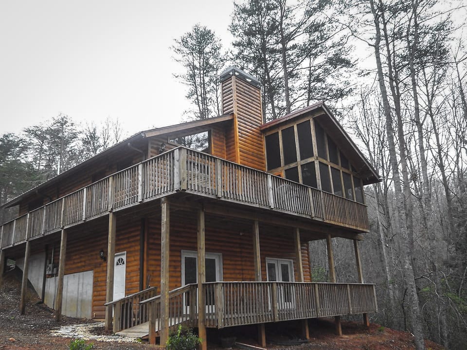 Two decks with wooded views and a screened in patio with hot tub 