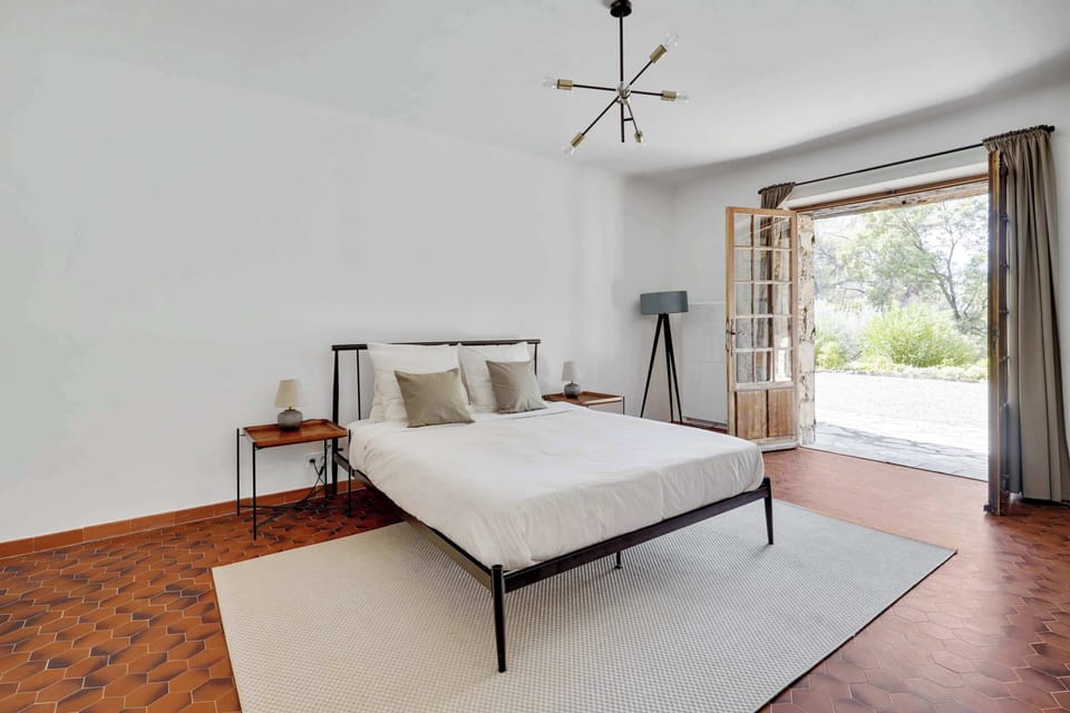 Vintage styled bedroom with a king bed with garden views 