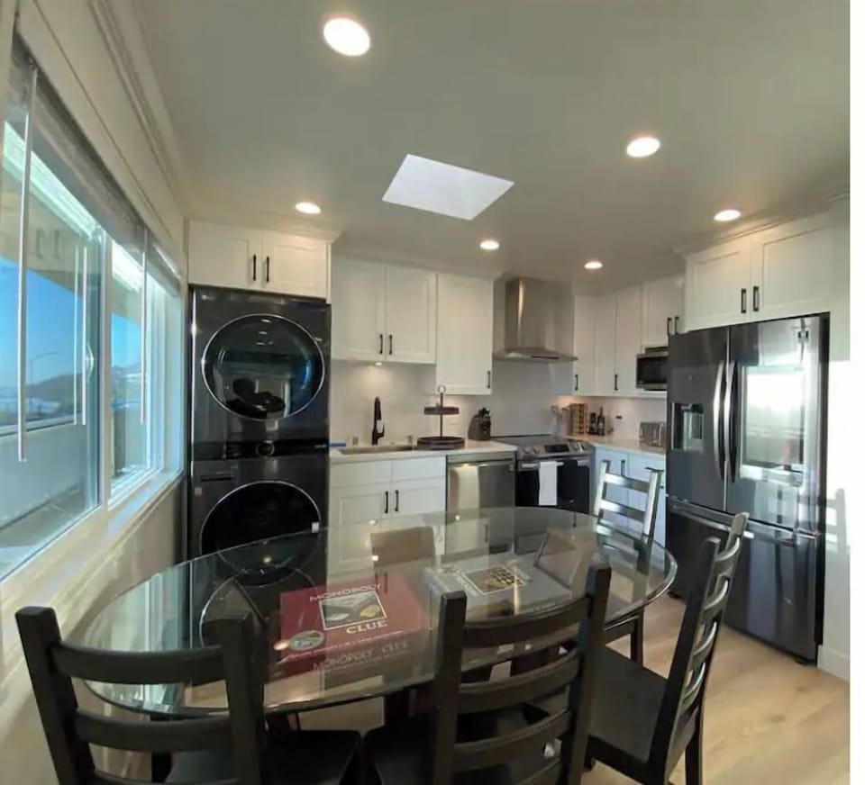 Kitchen with a smart refrigerator, W/D, dishwasher, microwave, range and table