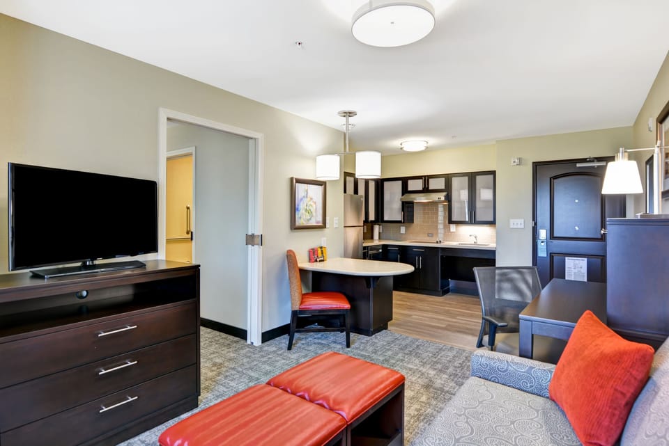 Living area with kitchen, television, and seating.