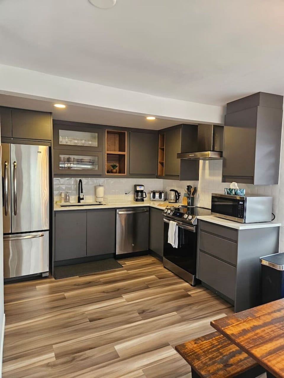 Kitchen (Main Floor): Modern, fully equipped kitchen with stainless steel appliances, thoughtfully stocked for convenience and seamless extended stays