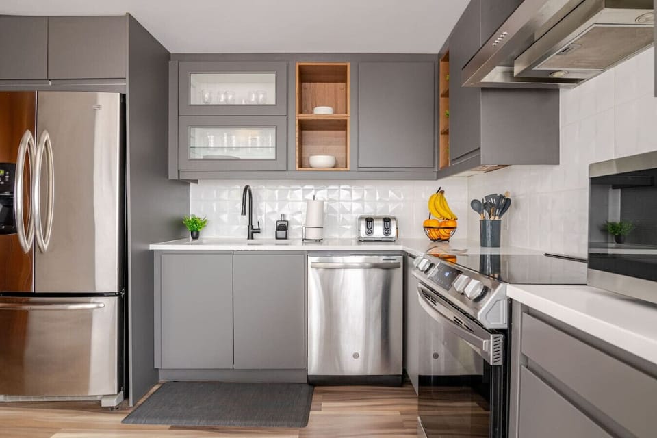 Kitchen (Main Floor): Generous cabinet space for storage, with cleaning supplies conveniently located under the sink, plus a dishwasher with soap provided for effortless cleanup