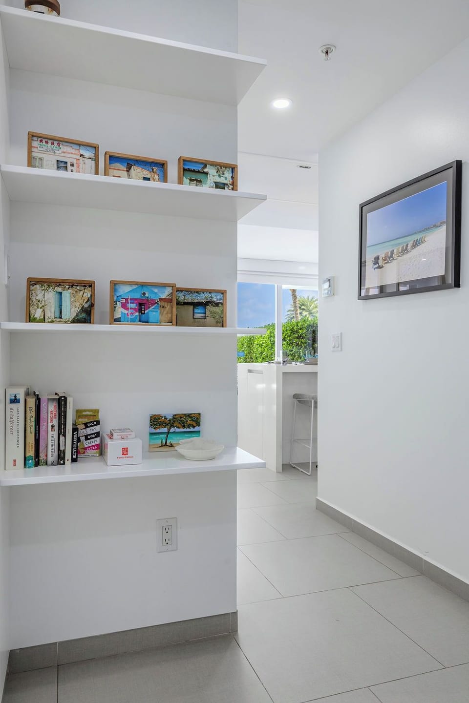 A bright, airy reading nook showcases coastal-inspired decor and natural light, perfect for unwinding with a good book during your stay.