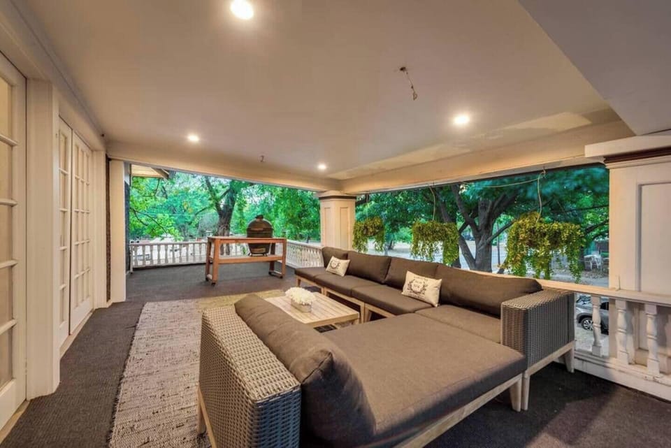 A stylish terrace featuring outdoor living room seating and a Big Green Egg Grill, offering the perfect setting for entertaining in comfort and style.