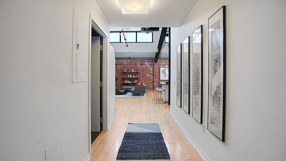 Foyer/entry hallway. The doorway on left leads to the bathroom.