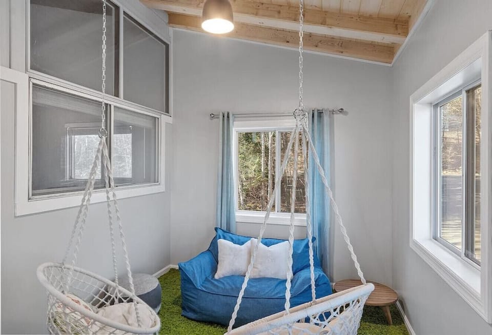 Loft area on second floor with two kids swing chairs and a small seating.
