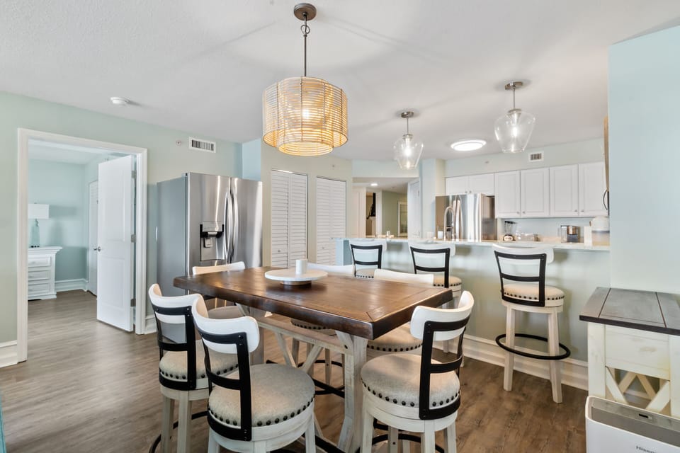 Your spacious dining area flows seamlessly into the modern kitchen, perfect for hosting memorable meals with stunning pendant lighting overhead.