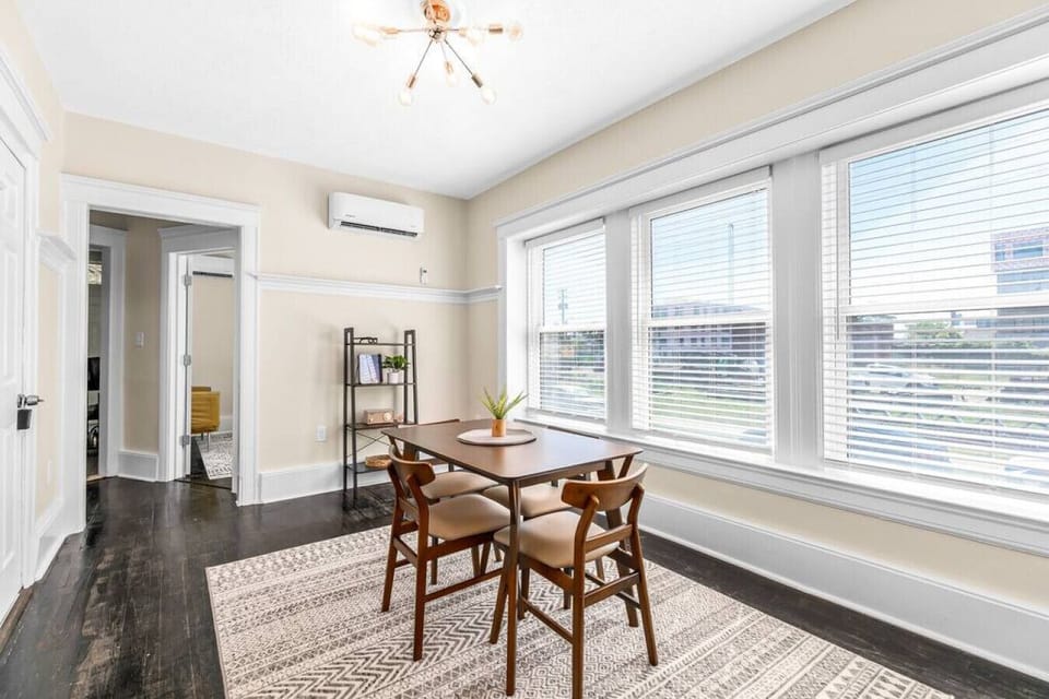 Modern dining area with natural light and seating for four.