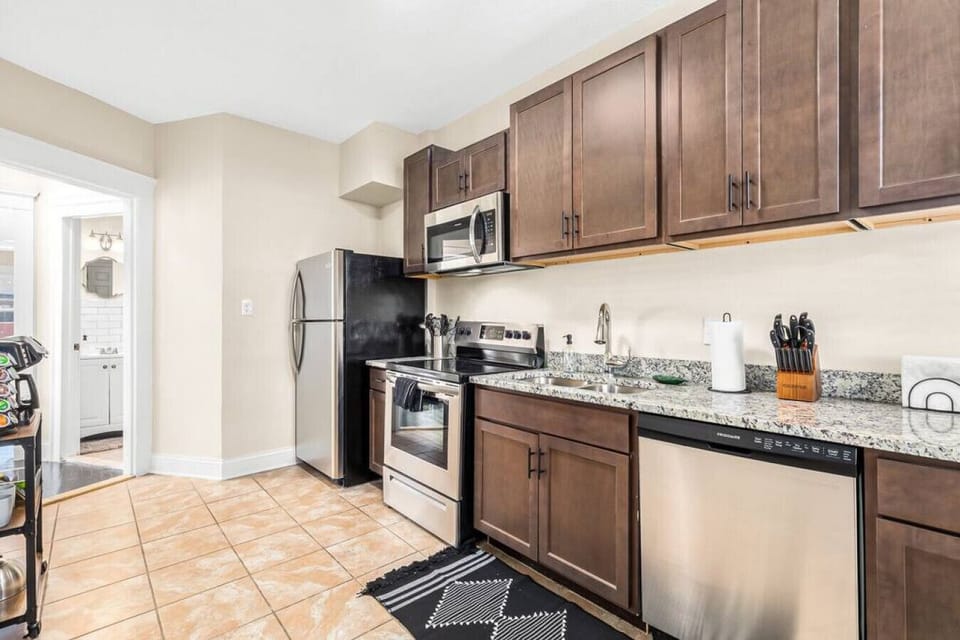 Prep a meal in the full sized kitchen with stainless steel appliances including: microwave, stove and oven, dishwasher, sink with garbage disposal, and fridge.