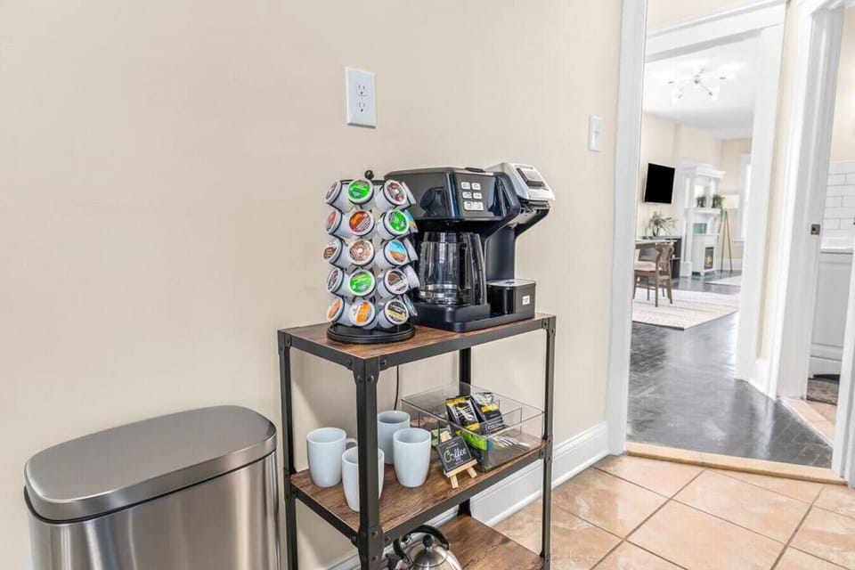 Brew a pot or cup of coffee on the stocked coffee cart with brew pot and one cup capabilities, coffee, creamer, tea, and tea kettle.