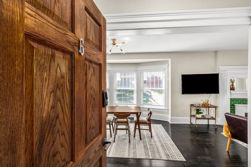 Admire the original wood doors that open into the unit.