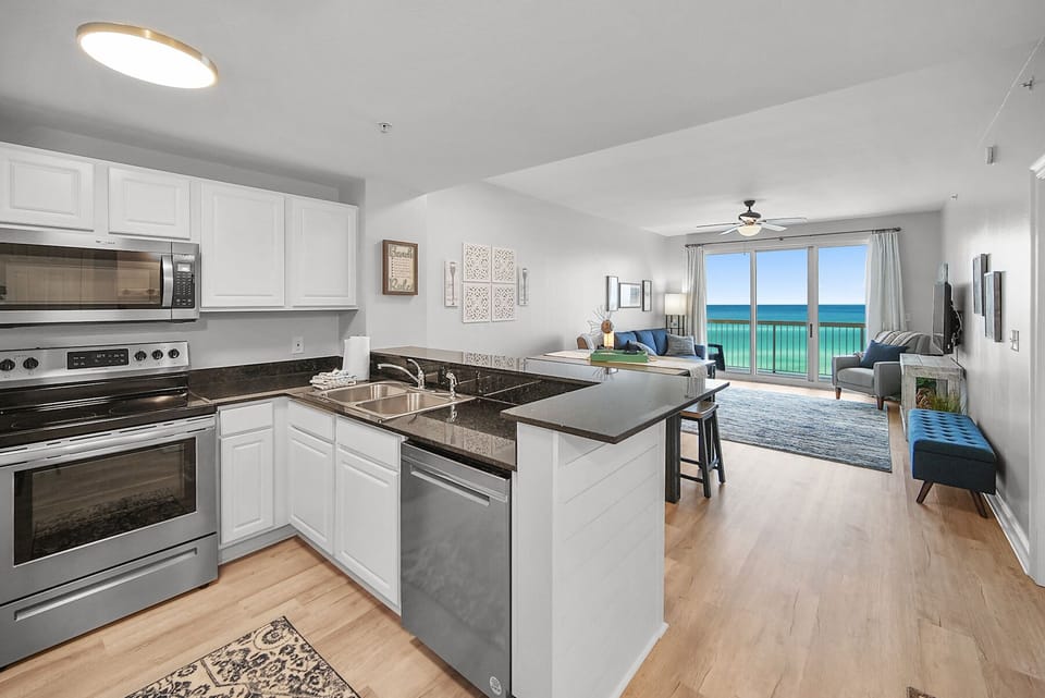 Your modern kitchen flows seamlessly into the living area, where stunning ocean views create the perfect backdrop for cooking and relaxation.