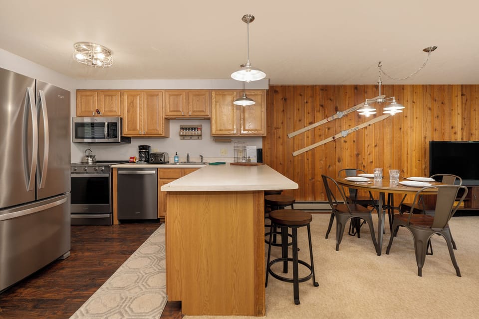 Your spacious kitchen features modern appliances, a convenient island, and cozy dining area perfect for preparing meals and gathering together.