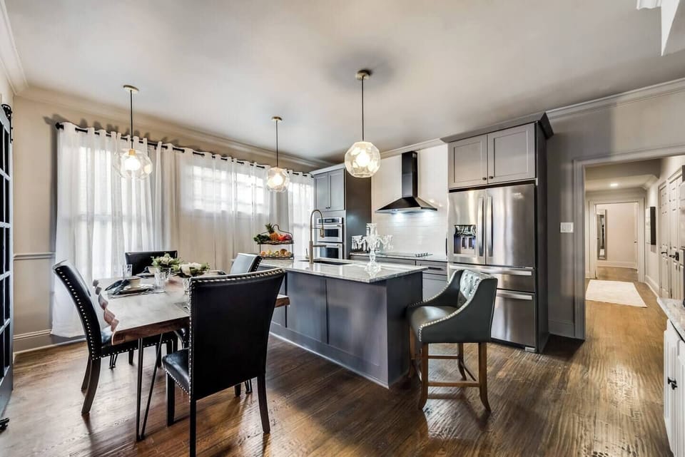 The fully equipped kitchen boasts a spacious island and stunning marble countertops, offering a bright and inviting space for all your cooking needs.