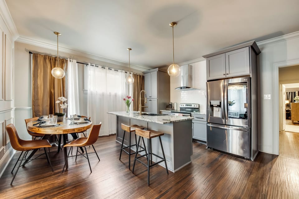 The fully equipped kitchen features a spacious island, plenty of counter space, and stunning marble countertops. With abundant natural light, it's the perfect space for preparing a gourmet meal or entertaining guests.