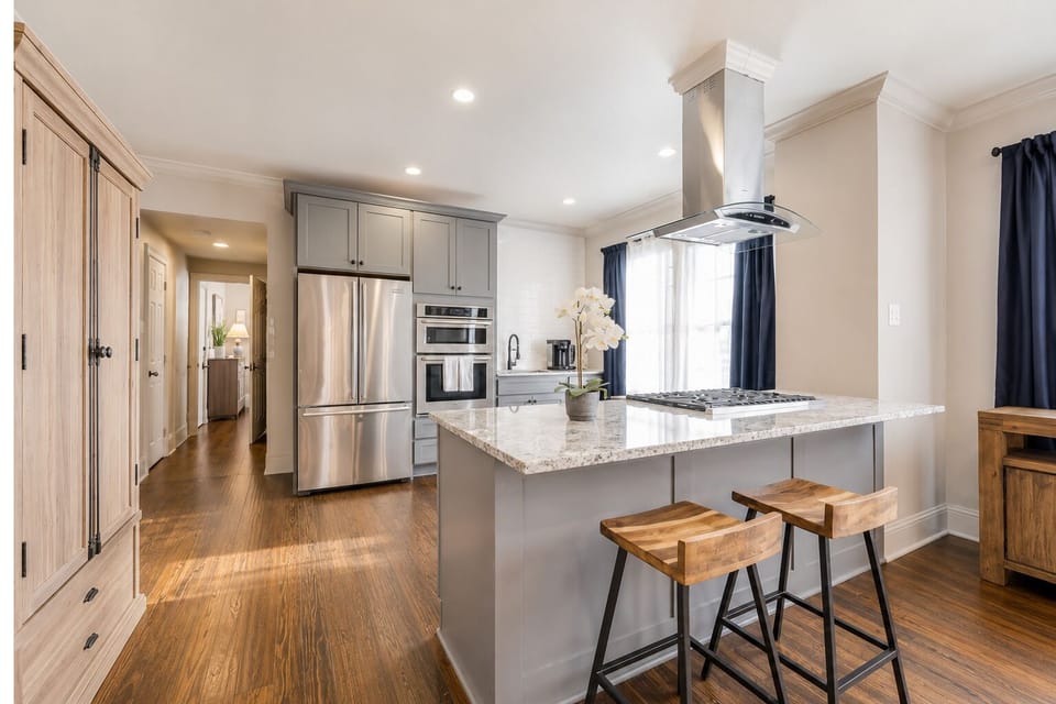 The fully equipped kitchen features a spacious island, plenty of counter space, and stunning marble countertops. With abundant natural light, it's the perfect space for preparing a gourmet meal or entertaining guests.