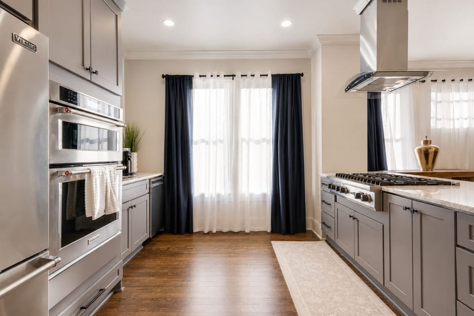 The kitchen is equipped with a Viking refrigerator and double oven, along with a spacious island, making it perfect for preparing a delicious meal.