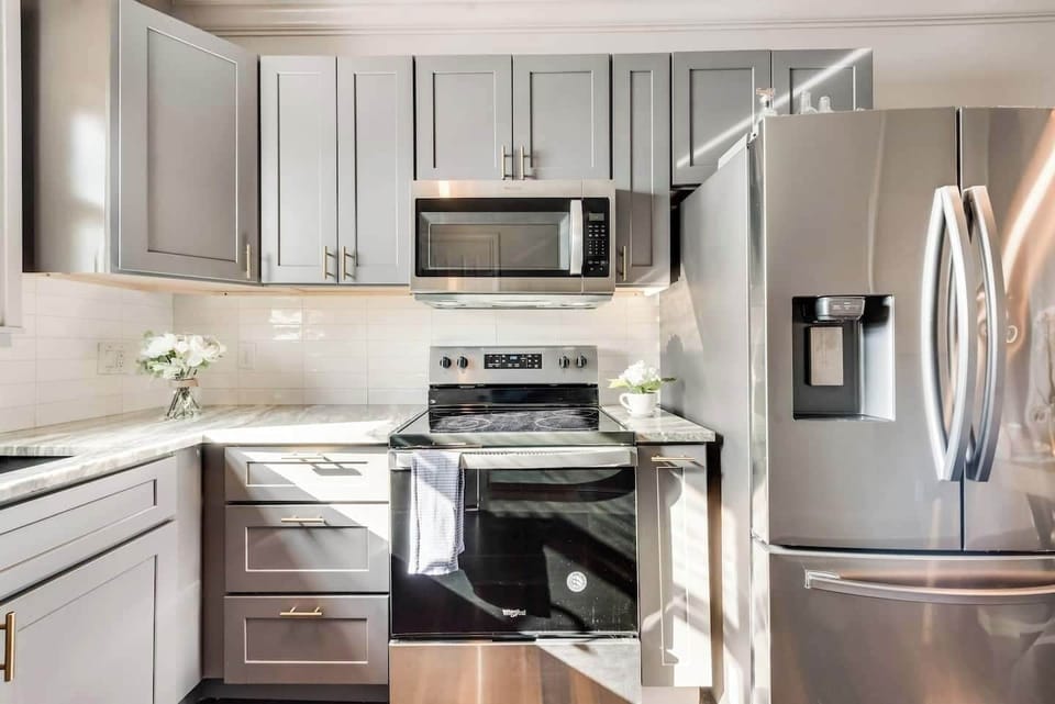 Fully equipped kitchen with modern appliances including french door LG refrigerator