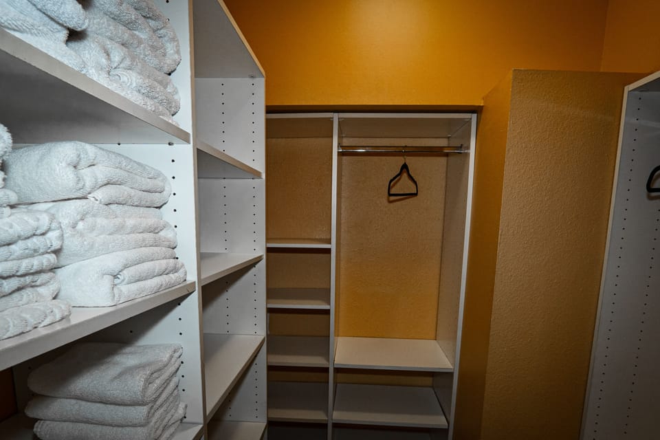 spacious closet filled with lots of towels