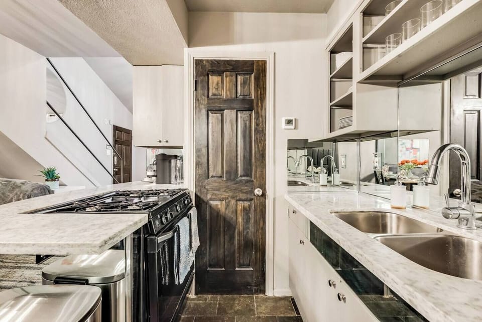 Fully equipped kitchen with gas stove and Nespresso machine.