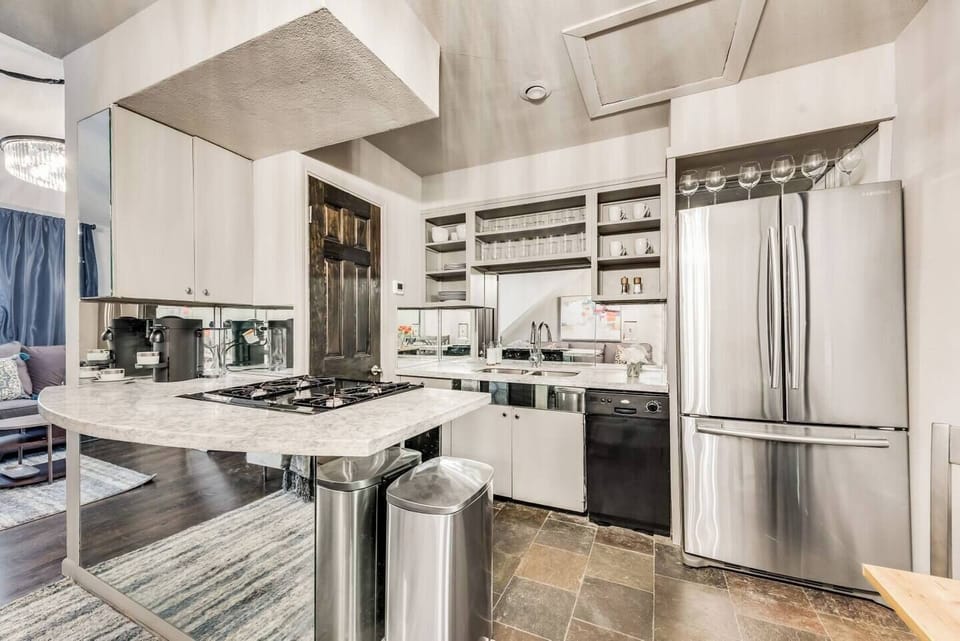 Fully equipped kitchen with French door, refrigerator, dishwasher, guest of at all the cooking essentials.