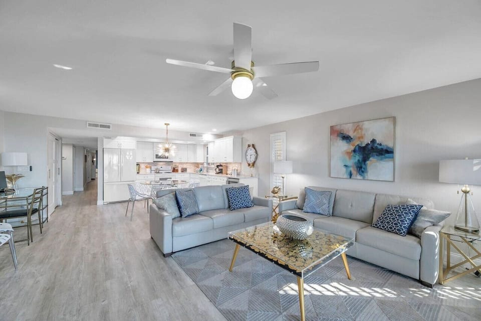 Open living room w/ plush seating and bright coastal style, designed for easy lounging and conversation.