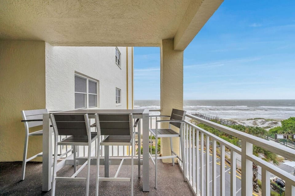 Covered balcony w/ seating, ideal for morning coffee or unwinding while enjoying fresh air.