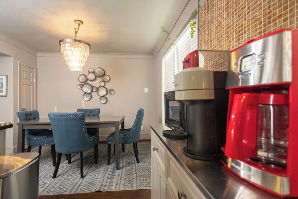 Intimate dining nook with plush seating, modern lighting, and direct access to the kitchen — ideal for cozy meals or morning coffee.