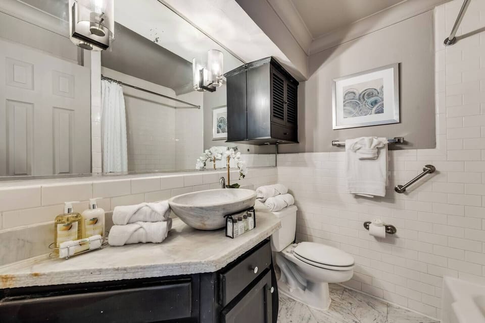 Exquisite white careers marble bath with tub and  shower.