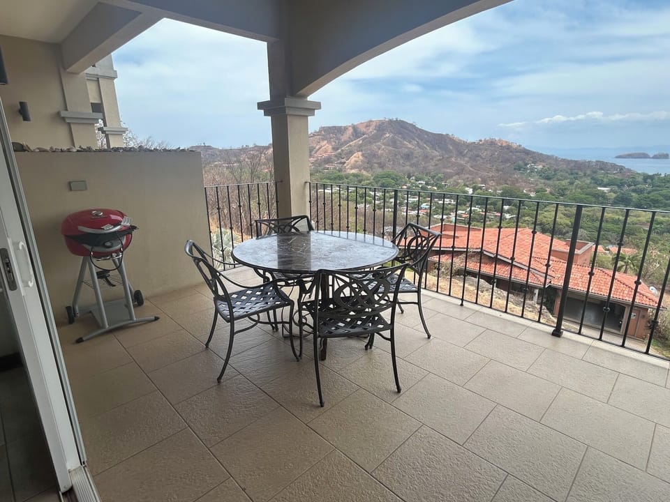 Outdoor Dining Area Under Large Covered Balcony with BBQ