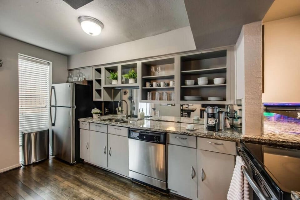 The kitchen is generously sized and boasts sleek, contemporary appliances, fully outfitted to meet all your cooking and dining needs.
