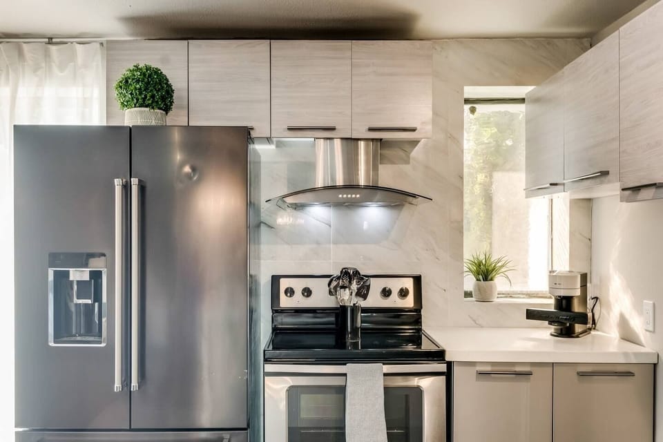 Spacious kitchen with sleek, modern appliances, fully equipped for all your cooking and dining needs with an extra large fridge. 