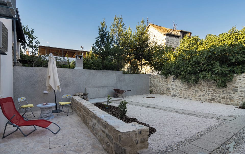 Private backyard with an outdoor furniture and outdoor shower.