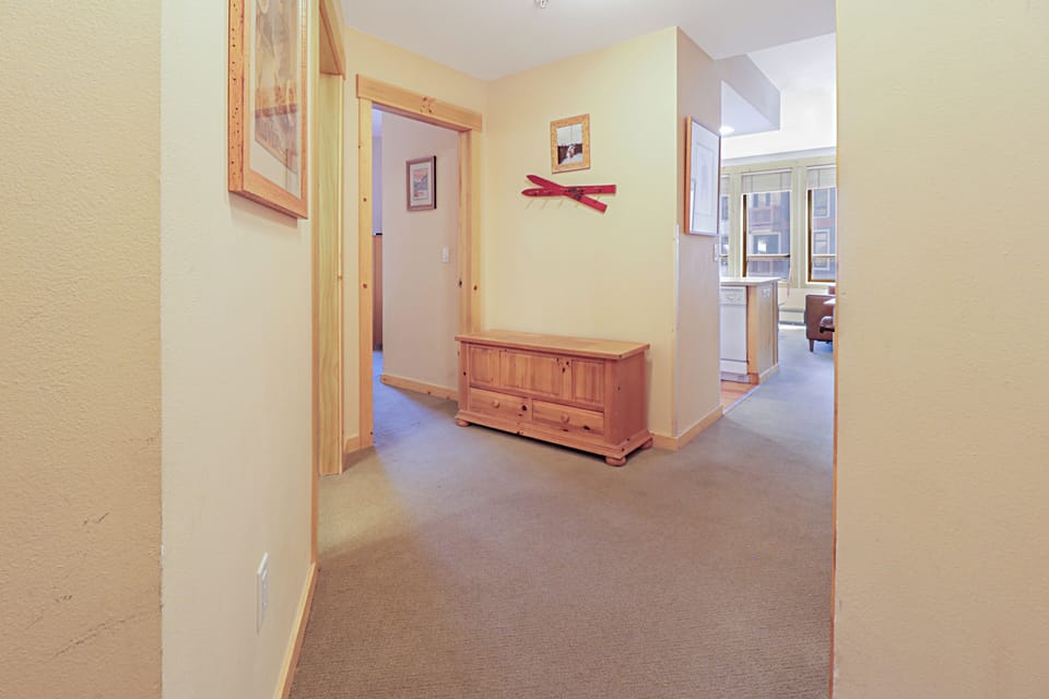 Step into your welcoming hallway with warm wood accents and thoughtful storage, creating a cozy entry to your mountain retreat.